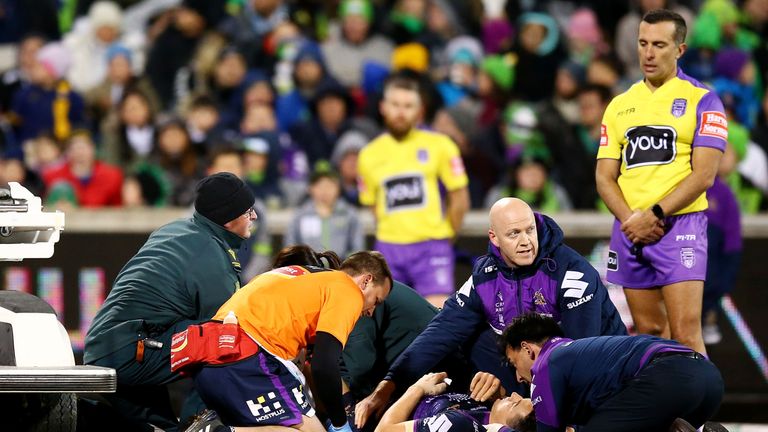 Billy Slater receives treatment after a tackle by Canberra's Iosia Soliola