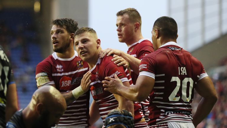 George Williams is congratulated after scoring Wigan's third try against Leeds