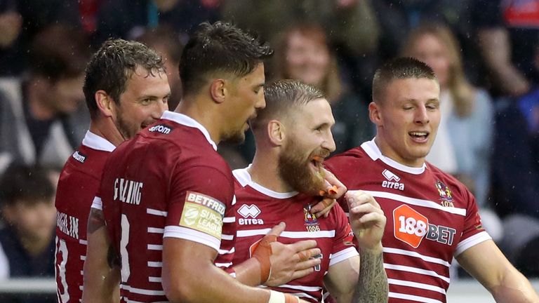 Sam Tomkins (second from right) is congratulated after scoring a try against Leeds
