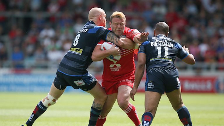 Josh Jones of Salford Red Devils is tacked by Keith Galloway of Leeds Rhinos and Jamie Jones-Buchanan