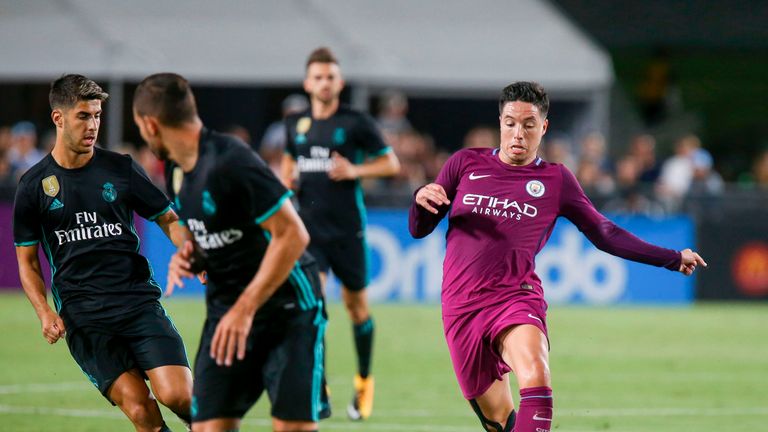 Manchester City midfielder Samir Nasri, right, drives the ball against Real Madrid during the second half of the International Champions Cup match on July 