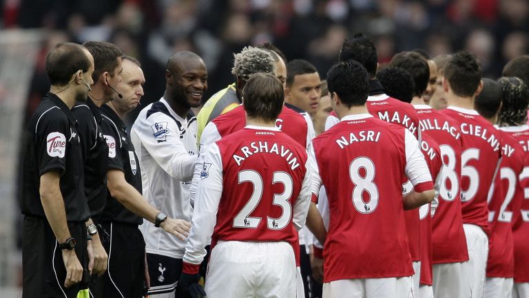 Tottenham Hotspur's French defender William Gallas (3rd L) in the line-up to shake hands with the Arsenal team before kick off in the English Premier Leagu