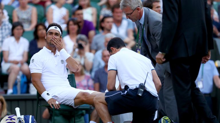Fabio Fognini of Italy is given assistance during the Gentlemen's Singles third round match against Andy Murray