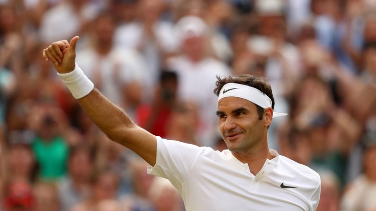 Roger Federer of Switzerland acknowledges the crowd as he celebrates victory at Wimbledon