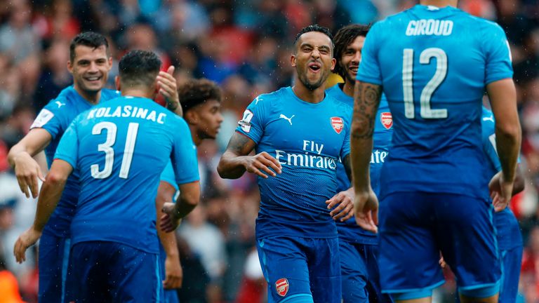 Theo Walcott celebrates with Arsenal team-mates at the Emirates