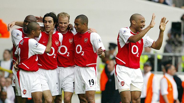 LONDON, UNITED KINGDOM:  Arsenal's French forward Thierry Henry (R) celebrates as teammate Robert Pires (3rdL) is mobbed by Patrick Vieira (L), Ashley Cole