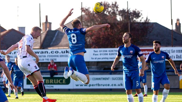 Ross County's Thomas Mikkelson heads home the opener at Links Park