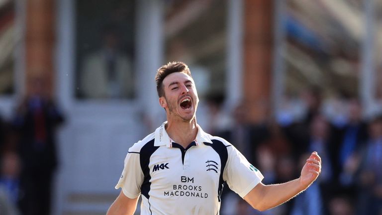 Toby Roland-Jones celebrates taking a wicket for Middlesex