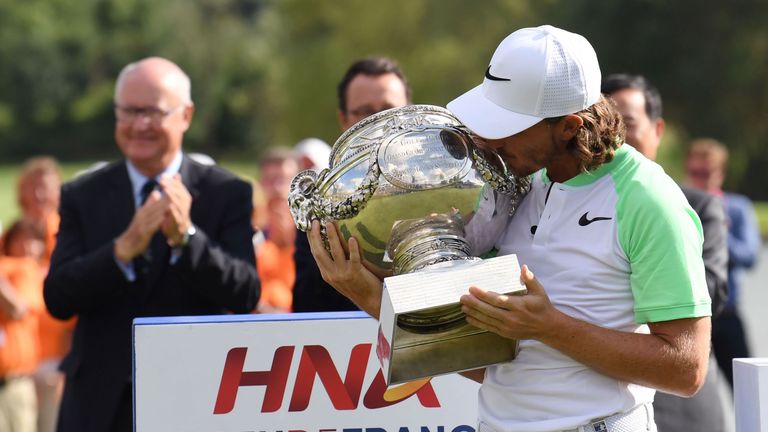 British player Tommy Fleetwood poses with the cup after winning the HNA Open de France golf tournament on July 2, 2017 at Le Golf National in Guyancourt, n