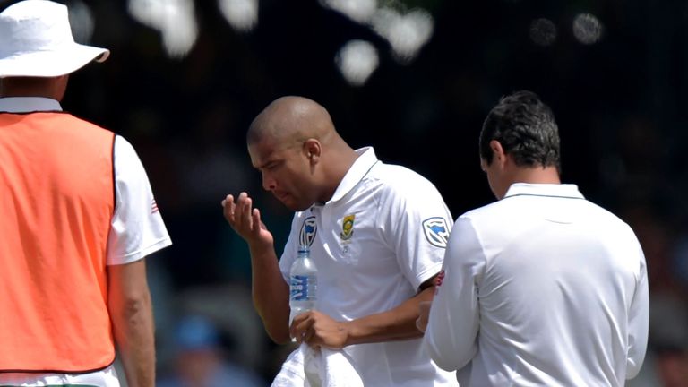 South Africa's Vernon Philander examines his injured hand during the third day of the first Test match between England and South Africa at Lord's Cricket G