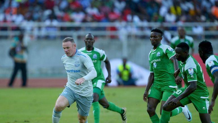 Everton's English striker Wayne Rooney (L) runs with the ball during a SportsPesa Super Cup final football match against Gor Mahia in Dar-es-Salaam