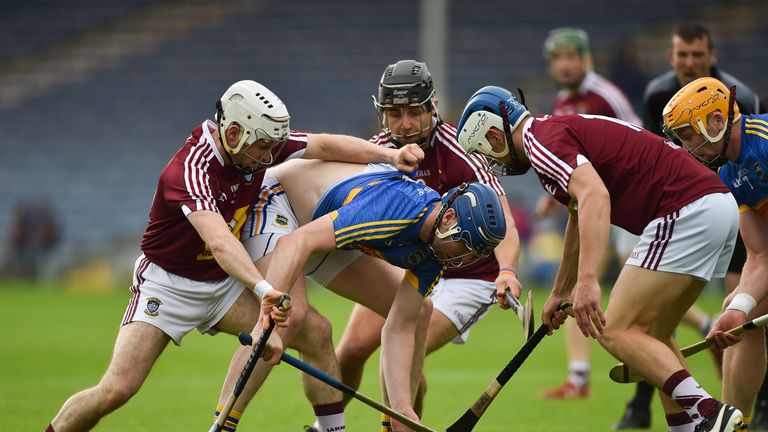 Tomas Hamill of Tipperary in action against , from left, Allan Devine, Robbie Greville, and Joey Boyle of Westmeath 