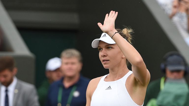 Romania's Simona Halep waves after beating New Zealand's Marina Erakovic during their women's singles first round match