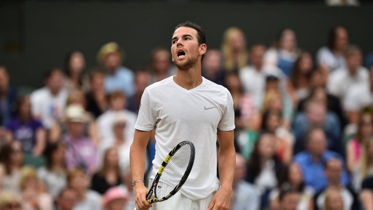 France's Adrian Mannarino reacts after a point against Serbia's Novak Djokovic during their men's singles fourth round match on the eighth day