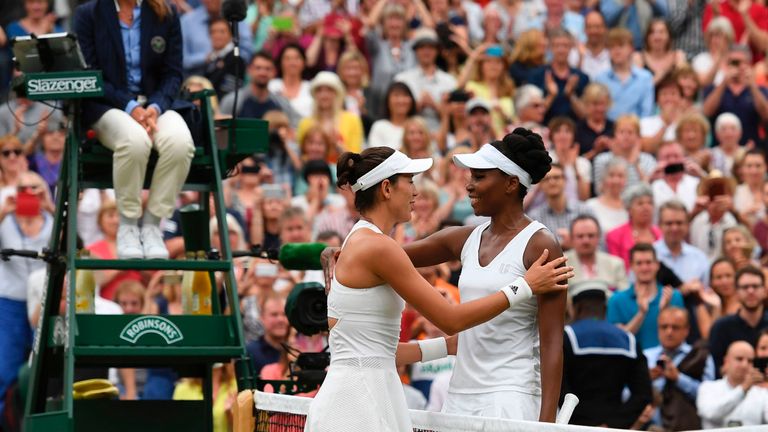 Spain's Garbine Muguruza (L) hugs US player Venus Williams after winning their women's singles final match on the twelfth day of the 2017 Wimbledon