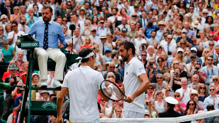Switzerland's Roger Federer shakes hands with Croatia's Marin Cilic after winning their men's singles final match on the last day of the 2017 Wimbledon