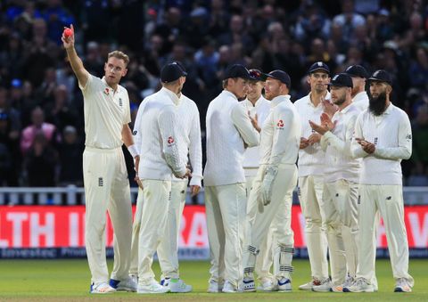 England bowler Stuart Broad (L) gestures after overtaking Ian Botham as England's second highest Test wicket-taker