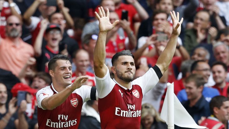 Arsenal's Bosnian defender Sead Kolasinac (R) celebrates with Granit Xhaka