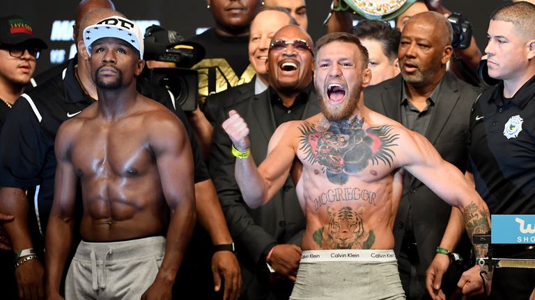LAS VEGAS, NV - AUGUST 25:  UFC lightweight champion Conor McGregor (R) screams after the face off with Floyd Mayweather Jr. during their official weigh-in
