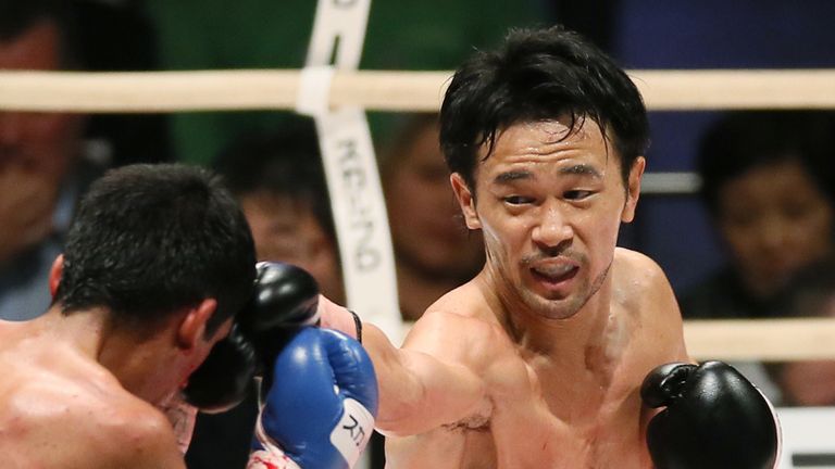 Champion Shinsuke Yamanaka (R) of Japan lands his right straight on Argentina's Diego Santillan during the WBC bantamweight title match in Osaka on April 1