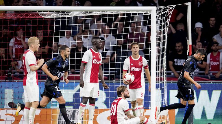 Nice's midfielders Lees-Melou (#7/R) and Valentin Eysseric (#13/C) are watched by Ajax players as they celebrate after their unseen teammate Vincent Marcel