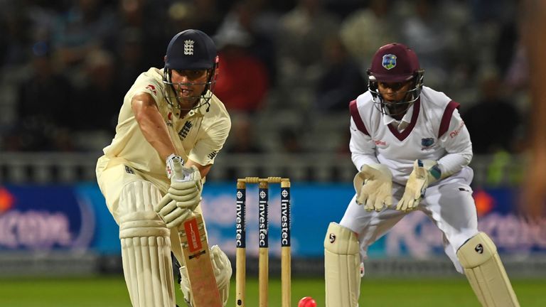 England's Alastair Cook (L) plays a shot, under lights on the first day of the first Test cricket match between England and the West Indies at Edgbaston