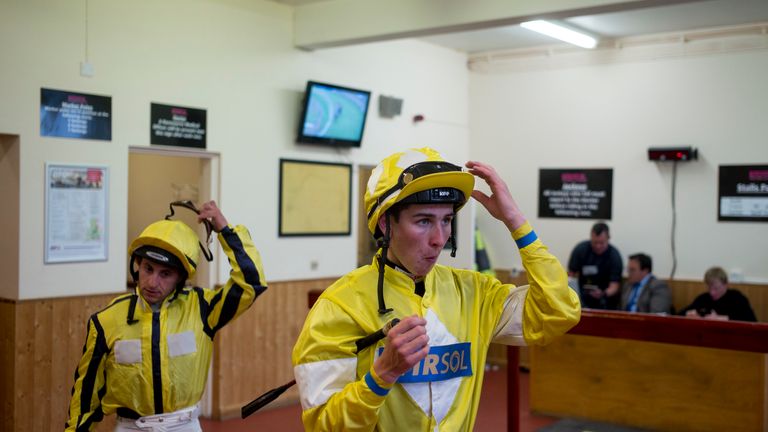 Jockeys Hector Crouch (R) and Nathan Alison leave the weighing room and head for the parade ring at Brighton 