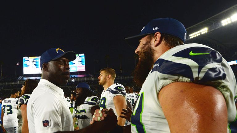 Coach Anthony Lynn of the Los Angeles Chargers shakes hands with Jordan Roos #64 of the Seattle Seahawks after Week One pre-season game in LA