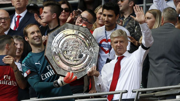Arsenal's French manager Arsene Wenger (R) and Petr Cech (L) hold up the trophy as they celebrate after their victory in the FA Community Shield