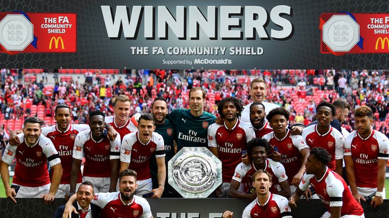 Arsenal team celebrate with the trophy following the The FA Community Shield final between Chelsea and Arsenal at Wembley Stadium