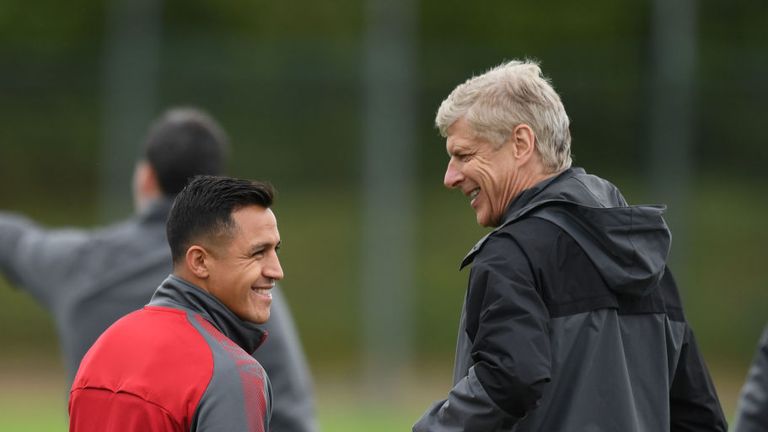 Arsene Wenger shares a joke with Alexis Sanchez at training today