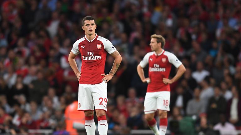 LONDON, ENGLAND - AUGUST 11:  (L-R) Granit Xhaka and Nacho Monreal of Arsenal look on after conceding a second first half goal during the Premier League ma