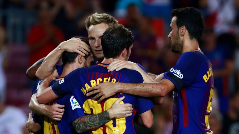 BARCELONA, SPAIN - AUGUST 20: Lionel Messi (L) of FC Barcelona celebrates scoring their opening goal with teammates Sergi Roberto (3ndL) Sergio Busquets Bu