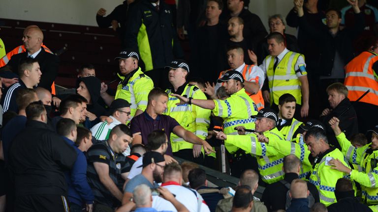 BURNLEY, ENGLAND - AUGUST 05: Police try to stop Hannover 96 fans who try to enter the Burnley end during the pre-season friendly match between Burnley and