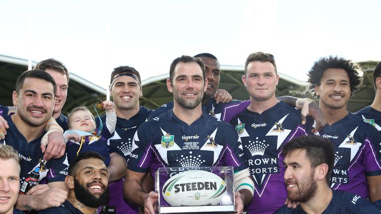 MELBOURNE, AUSTRALIA - JULY 30:  Cameron Smith of the Storm poses with his team mates after he played his 350th match during the round 21 NRL match between