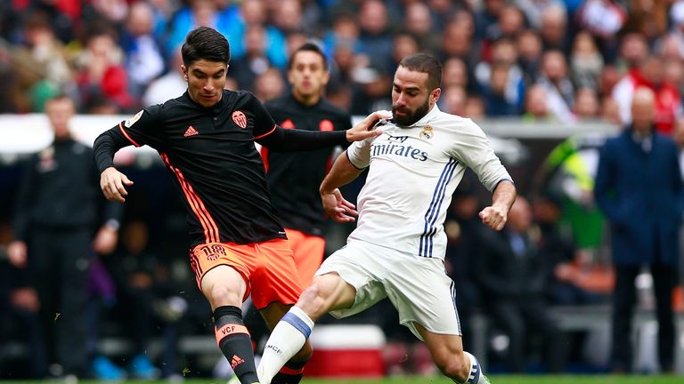 MADRID, SPAIN - APRIL 29: Daniel Carvajal (R) of Real Madrid CF competes for the ball with Carlos Soler (L) of Valencia CF during the La Liga match between