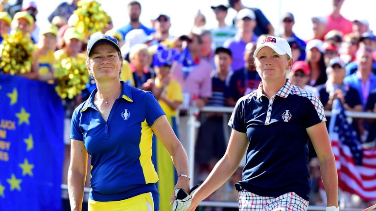 WEST DES MOINES, IA - AUGUST 20:  Catriona Matthew of Team Europe and Stacy Lewis of the United States tap one another as they leave the first tee during t