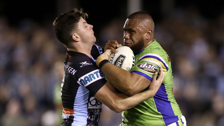 SYDNEY, AUSTRALIA - AUGUST 05:  Chad Townsend of the Sharks tackles Junior Paulo of the Raiders during the round 22 NRL match between the Cronulla Sharks a