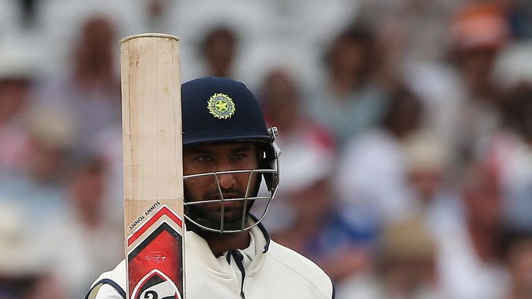 India's Cheteshwar Pujara celebrates reaching a half century  (50 runs) during the fourth day of the first cricket Test match between England and India at 