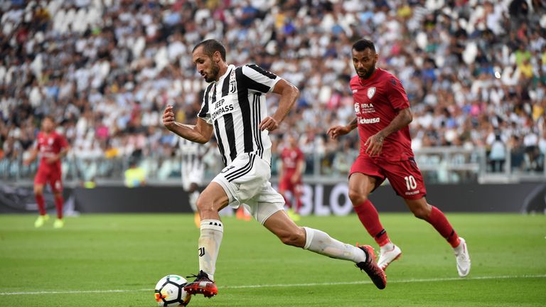 TURIN, ITALY - AUGUST 19:  Giorgio Chiellini of Juventus competes for the ball with Geraldino Joao Pedro of Cagliari Calcio during the Serie A match betwee