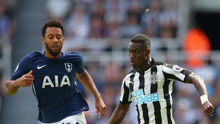 Christian Atsu of Newcastle United attempts to get past Mousa Dembele 