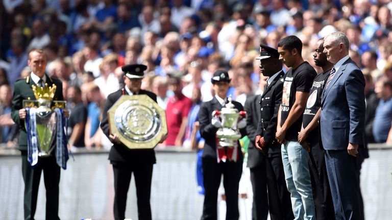FA chairman Greg Clarke (right) and guests observe a minutes silence in memory of the Grenfell Tower victims before the Community Shield at Wembley, London