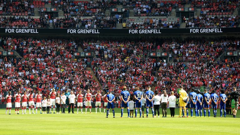 Both teams stand for a minutes silence in memory of the Grenfell Tower victims during the Community Shield at Wembley, London.