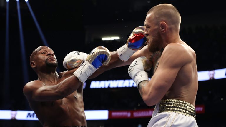 Conor McGregor throws a punch at Floyd Mayweather Jr