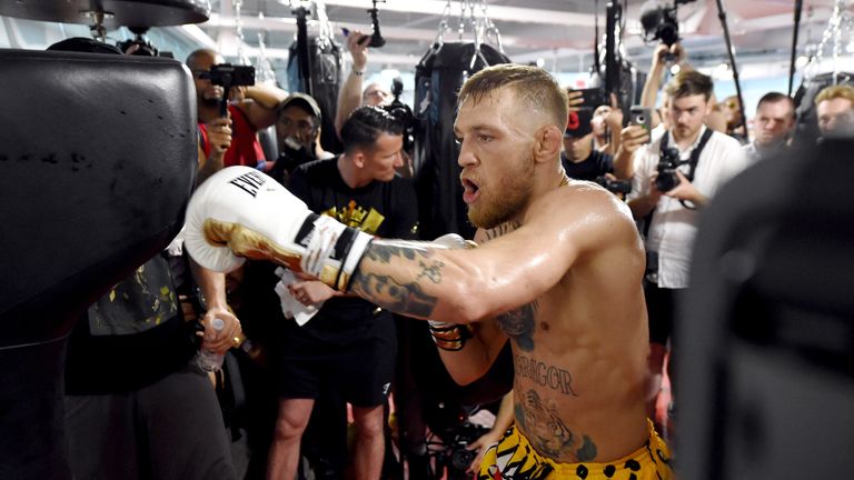 UFC lightweight champion Conor McGregor hits an uppercut bag during a media workout at the UFC Performance Institute on August 