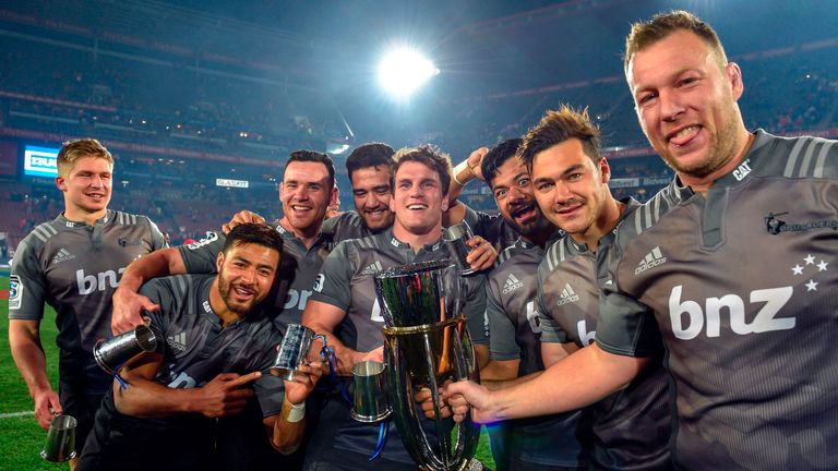 Crusaders'rugby team players celebrate with the trophy during the price ceremony after winning the Super XV rugby final match between Lions and Crusaders a