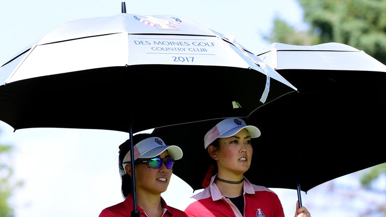 Kang and Michelle Wie shield themselves from the heat as they won the top fourballs match