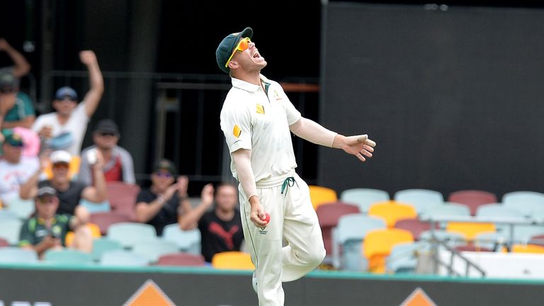 BRISBANE, AUSTRALIA - DECEMBER 19: David Warner of Australia celebrates after taking the catch to dismiss Asad Shafiq of Pakistan during day five of the Fi