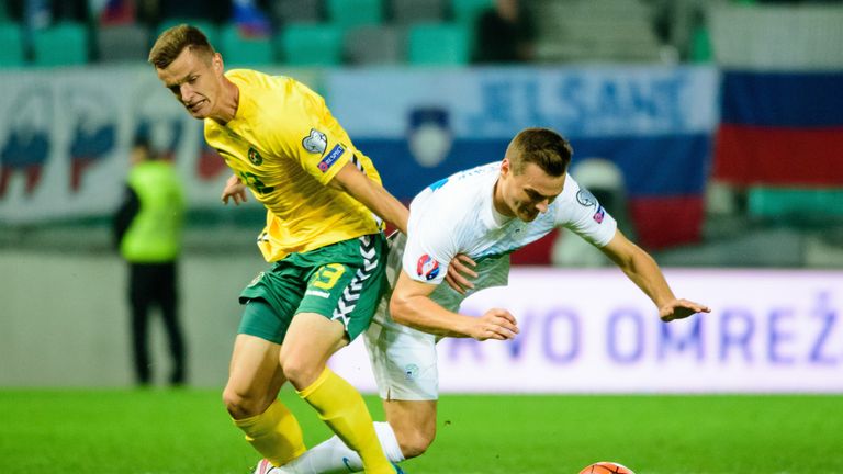 Lithuania's Deimantas Petravicius (L) vies with Slovenia's Nejc Pecnik during the Euro 2016 Group E qualifying football match between Slovenia and Lithuani