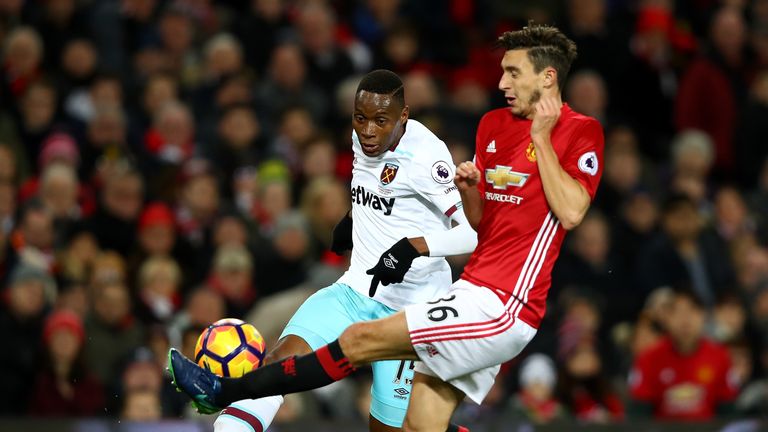 MANCHESTER, ENGLAND - NOVEMBER 27: Diafra Sakho of West Ham United (L) and Matteo Darmian of Manchester United (R) battle for possession during the Premier